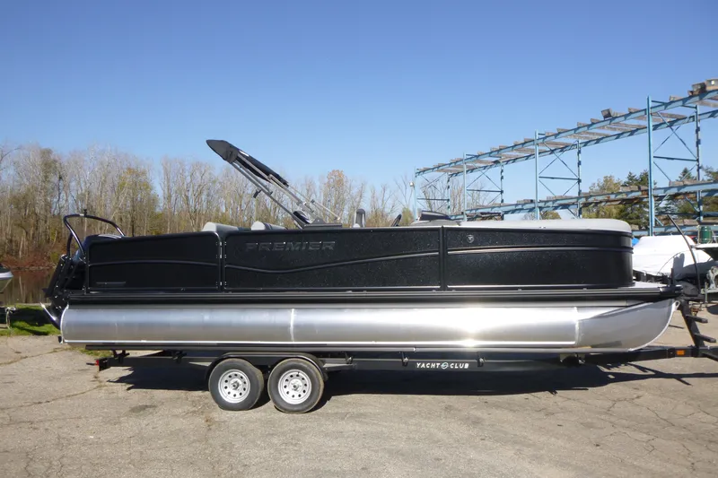 Slide: The Image of 2027 Premier 250 SUNSATION RLO - CL pontoon boat on trailer, outdoors. - 1