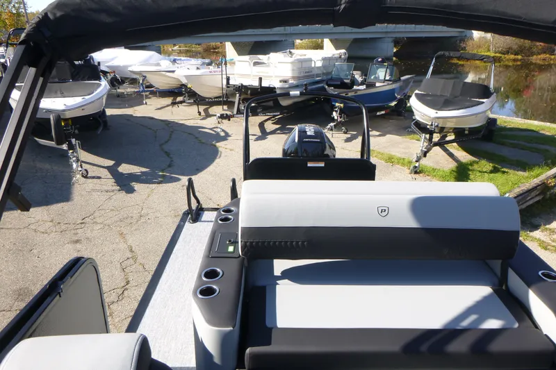 Slide: The Image of 2027 Premier 250 SUNSATION RLO - CL pontoon boat at marina with other boats. - 23