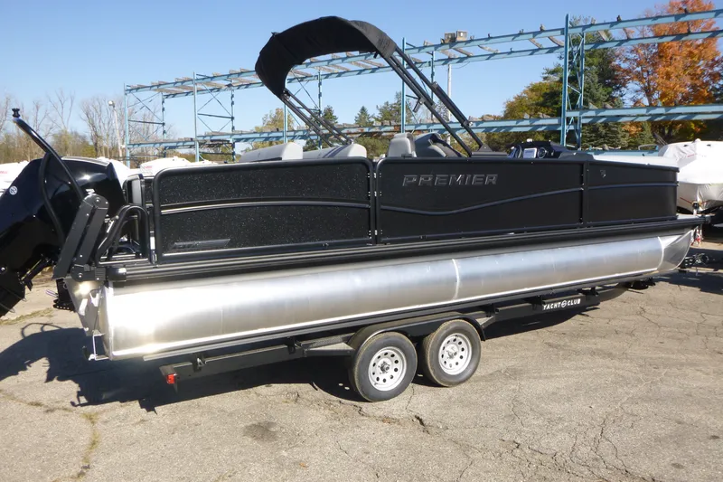 Slide: The Image of 2027 Premier 250 Sunsation RLO-CL pontoon boat on trailer, outdoor setting. - 2
