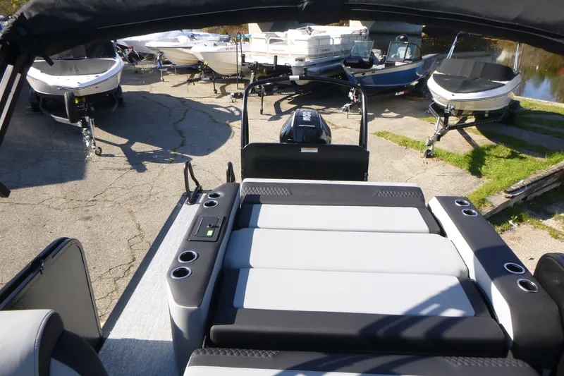 Slide: The Image of 2027 Premier 250 SUNSATION RLO - CL boat with sleek seating, docked among other boats. - 29