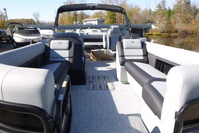 Slide: The Image of 2027 Premier 250 SUNSATION RLO - CL pontoon boat interior with plush seating and scenic background. - 14