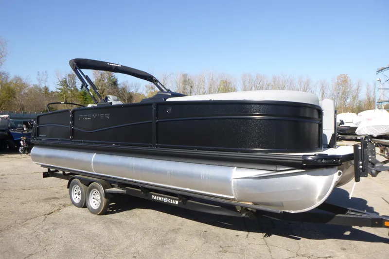 The Image of 2027 Premier 250 SUNSATION RLO - CL pontoon boat on trailer, outdoors. - 0
