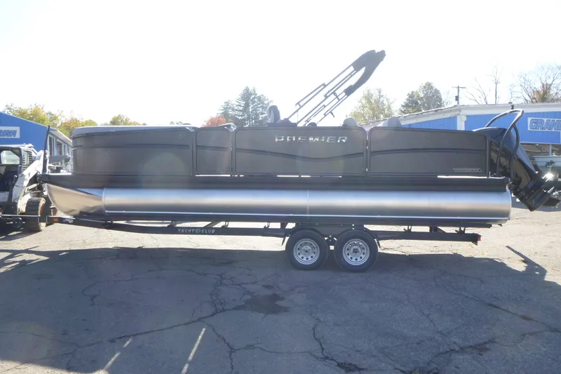 Slide: The Image of 2027 Premier 250 Sunsation RLO-CL pontoon boat on trailer, parked outdoors. - 7