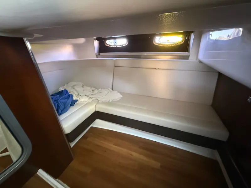 Slide: The Image of Interior of the 2018 Chaparral 337 SSX with white sofa and wooden floor. - 5