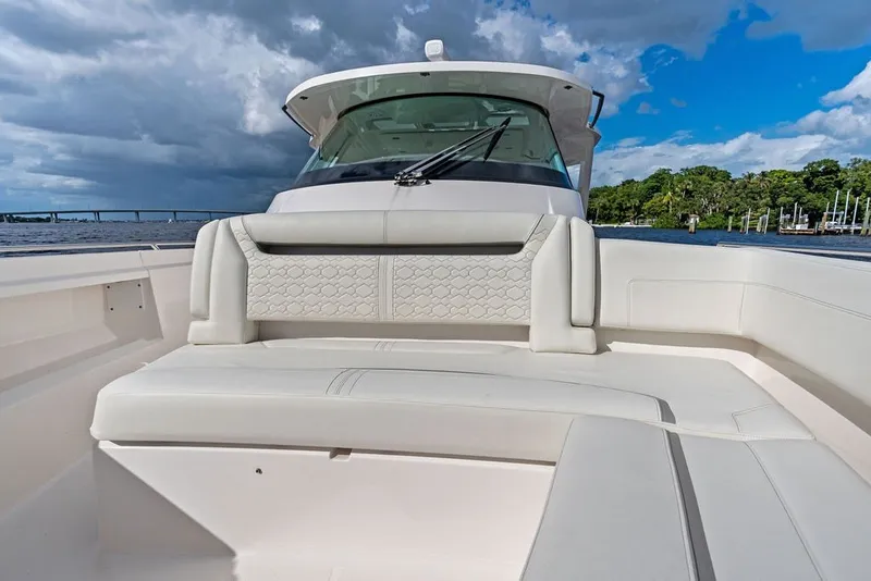 Slide: The Image of 2024 Tiara Yachts 38 LS boat with luxurious seating, scenic water view. - 26