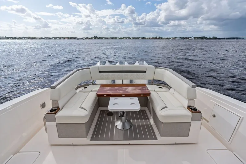 Slide: The Image of 2024 Tiara Yachts 38 LS luxury seating area with ocean view and elegant table. - 33