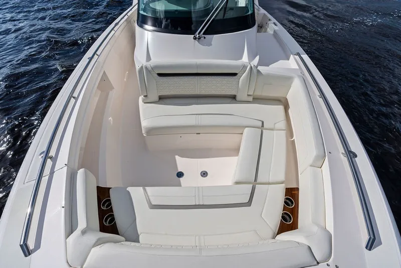 Slide: The Image of 2024 Tiara Yachts 38 LS boat with luxurious white seating and sleek design on the water. - 28