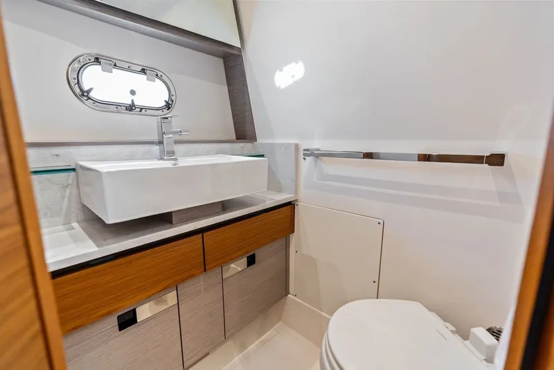 Slide: The Image of Luxurious bathroom interior of 2024 Tiara Yachts 38 LS with modern sink and porthole window. - 55