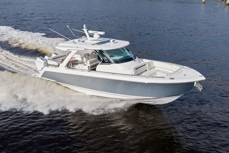 Slide: The Image of 2024 Tiara Yachts 38 LS cruising on open water, showcasing sleek design and performance. - 2
