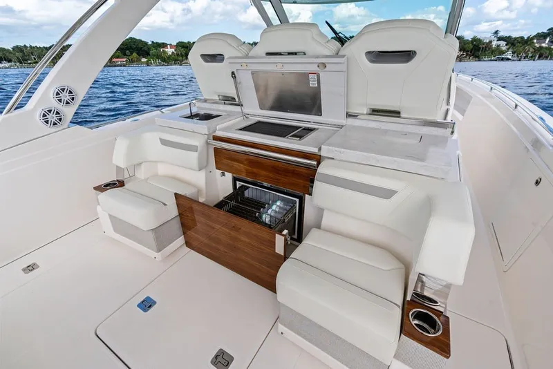 Slide: The Image of 2024 Tiara Yachts 38 LS interior with luxurious seating and modern amenities on open water. - 39