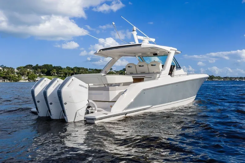 Slide: The Image of 2024 Tiara Yachts 38 LS on water, featuring triple Mercury outboard engines. - 7