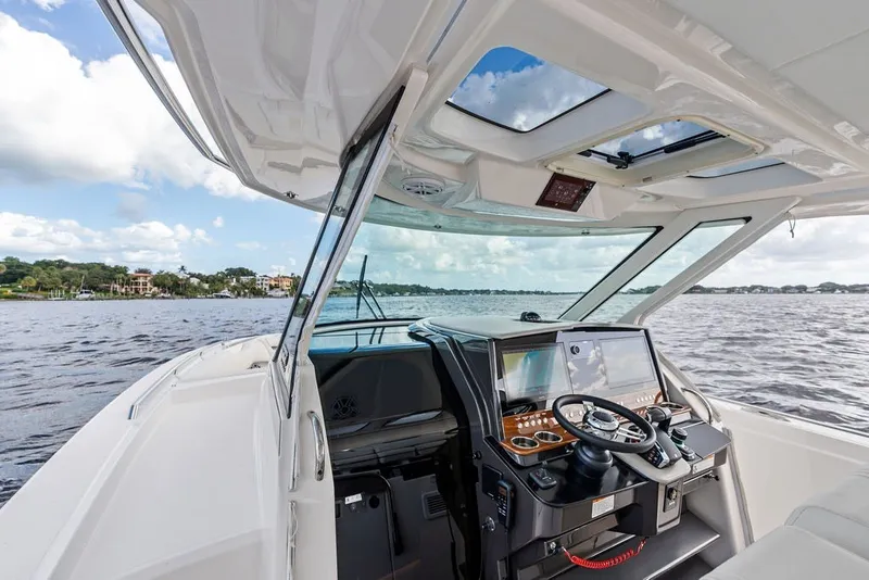 Slide: The Image of 2024 Tiara Yachts 38 LS helm with advanced navigation, open water view. - 49