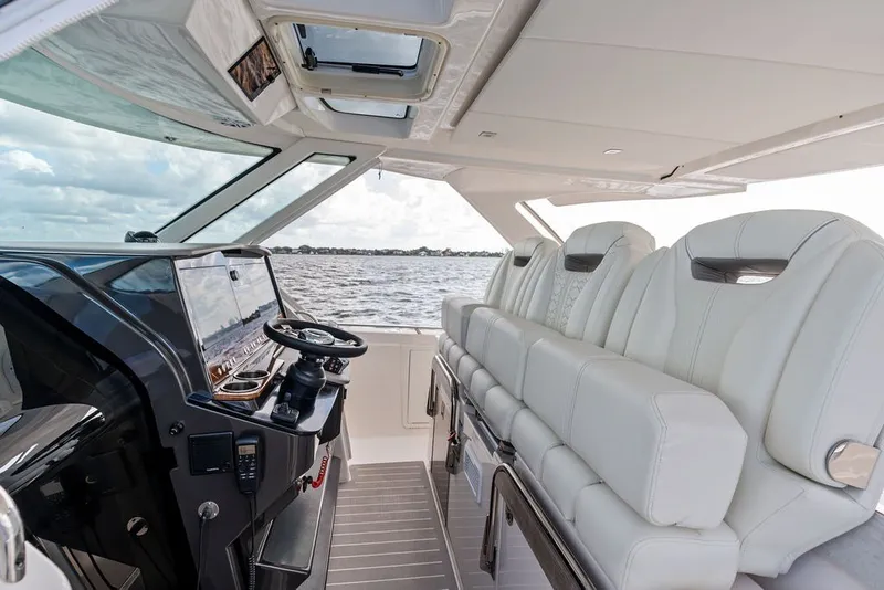 Slide: The Image of 2024 Tiara Yachts 38 LS interior with luxurious seating and modern helm controls. - 43