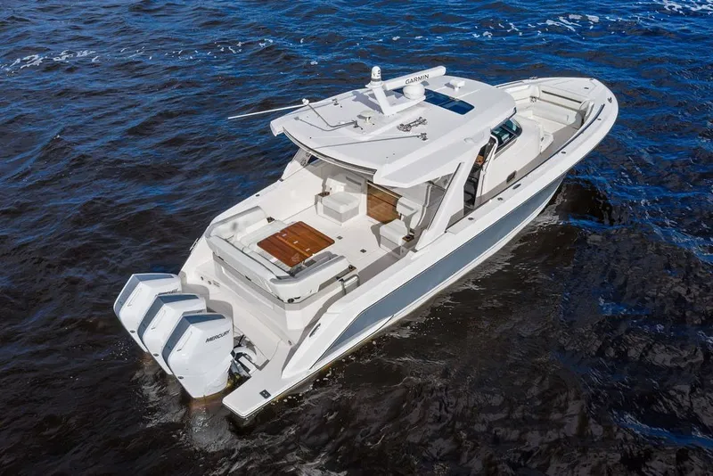 Slide: The Image of 2024 Tiara Yachts 38 LS on water, featuring sleek design and triple Mercury outboard engines. - 22