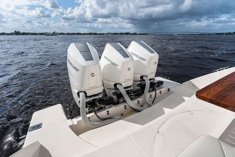 Slide: The Image of 2024 Tiara Yachts 38 LS with triple Mercury outboard engines on open water. - 37