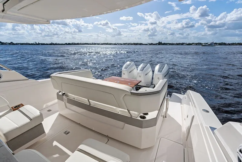 Slide: The Image of 2024 Tiara Yachts 38 LS with triple outboard engines on open water. - 36