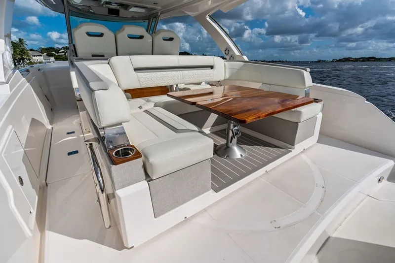 Slide: The Image of 2024 Tiara Yachts 38 LS luxury seating area with elegant table, ocean view. - 38