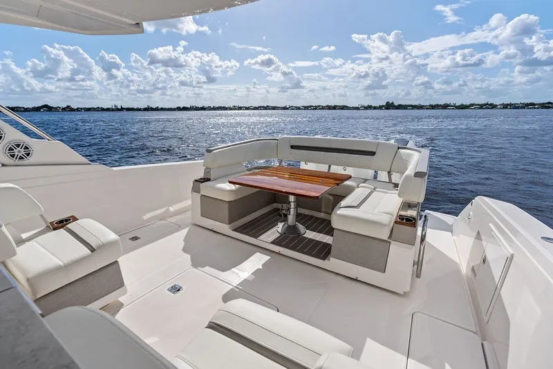 Slide: The Image of Luxurious seating area on 2024 Tiara Yachts 38 LS, overlooking serene ocean waters. - 31