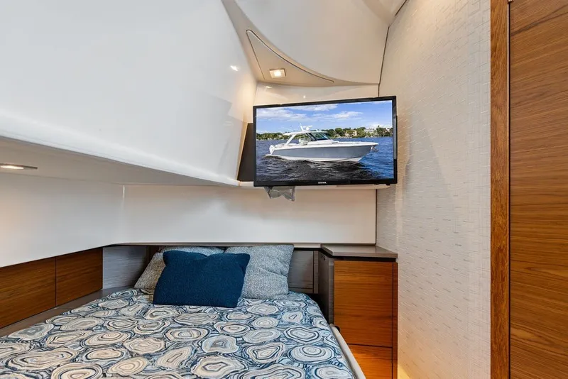 Slide: The Image of Luxurious cabin interior of 2024 Tiara Yachts 38 LS with TV and stylish bedding. - 53