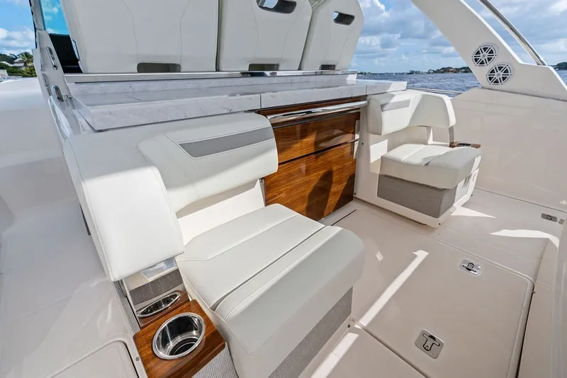 Slide: The Image of Luxurious seating area on 2024 Tiara Yachts 38 LS, featuring elegant wood accents and modern design. - 35