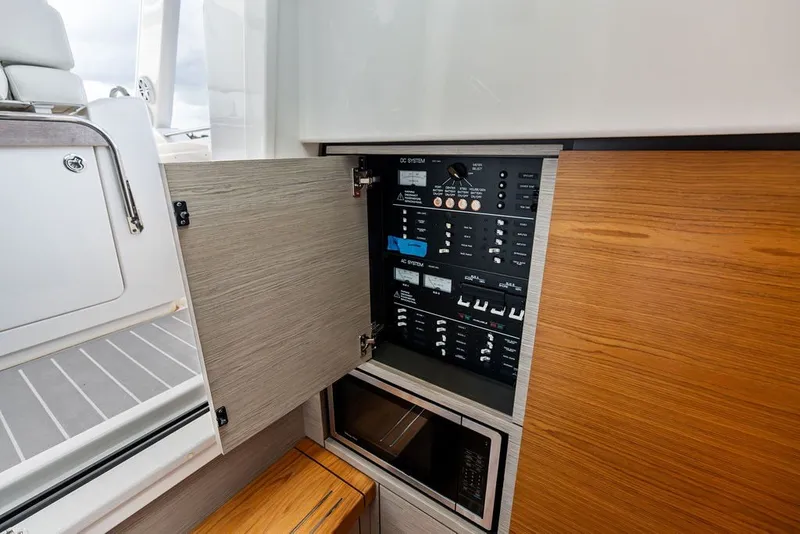 Slide: The Image of 2024 Tiara Yachts 38 LS interior showing control panel and microwave. - 57