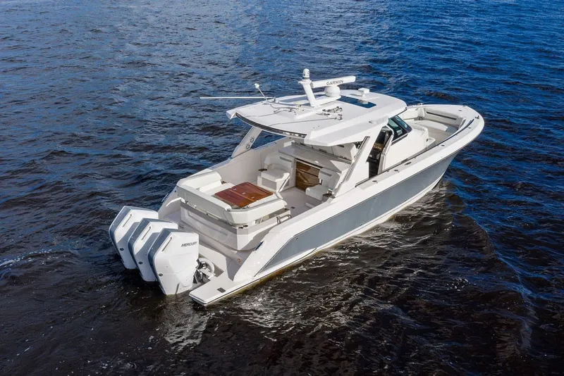 Slide: The Image of 2024 Tiara Yachts 38 LS cruising on open water, showcasing sleek design and powerful engines. - 6