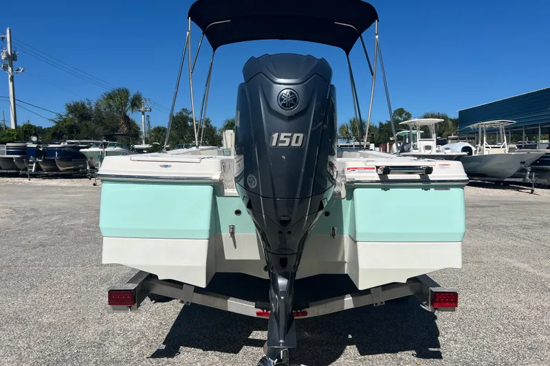 Slide: The Image of 2024 Robalo 206 Cayman boat with Yamaha 150 engine, parked outdoors. - 3