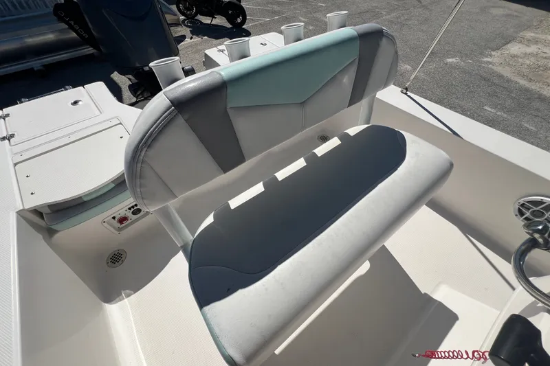 Slide: The Image of 2024 Robalo 206 Cayman boat interior with cushioned seating and control panel. - 10