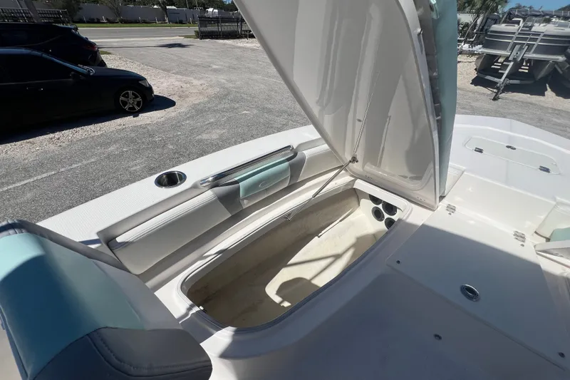 Slide: The Image of 2024 Robalo 206 Cayman boat with open storage compartment on deck. - 18