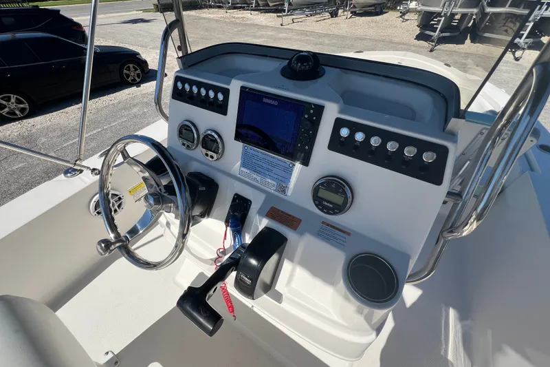 Slide: The Image of 2024 Robalo 206 Cayman boat dashboard with steering wheel and control panel. - 11
