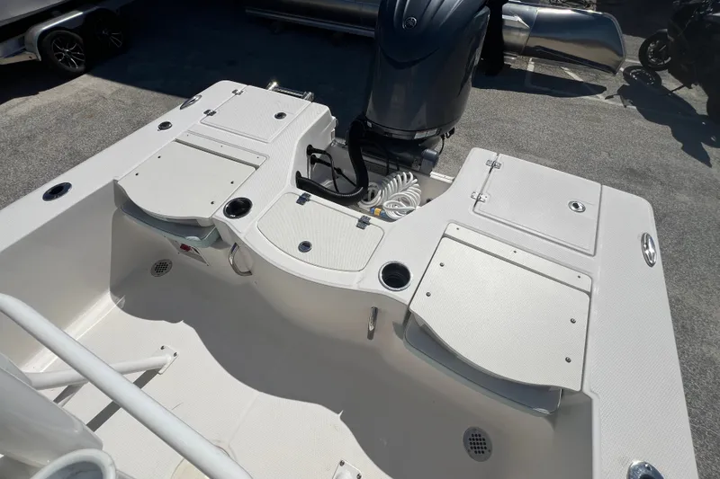Slide: The Image of 2024 Robalo 206 Cayman boat deck with storage compartments and outboard motor. - 7