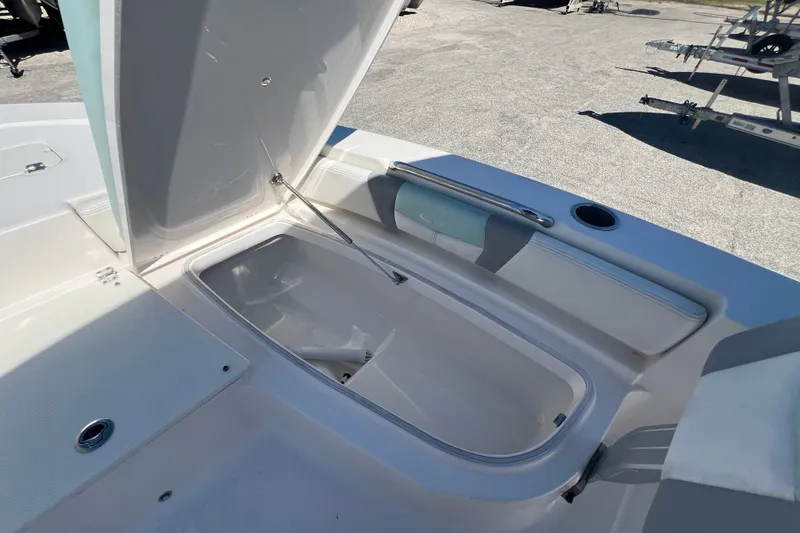 Slide: The Image of 2024 Robalo 206 Cayman boat storage compartment open on deck. - 19