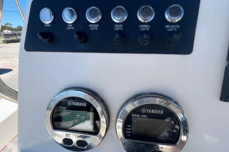 Slide: The Image of Control panel of 2024 Robalo 206 Cayman boat with Yamaha gauges and switches. - 12