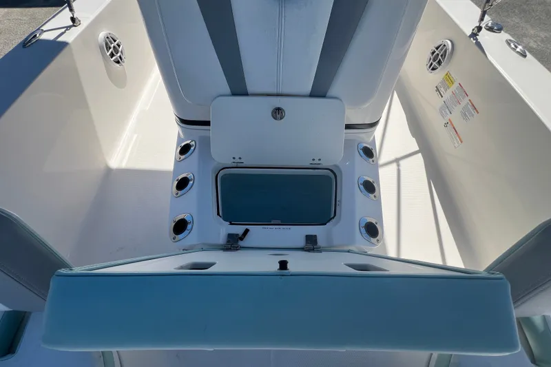 Slide: The Image of 2024 Robalo 206 Cayman boat interior with storage compartment and rod holders. - 16