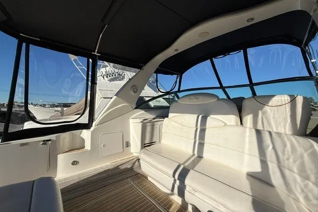 Slide: The Image of 2000 Sea Ray 340 Sundancer interior with white seating and panoramic windows. - 11