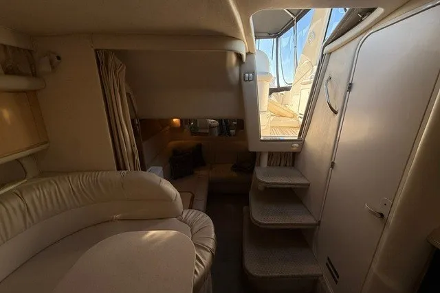 Slide: The Image of Interior of 2000 Sea Ray 340 Sundancer yacht with beige seating and stairs to deck. - 45