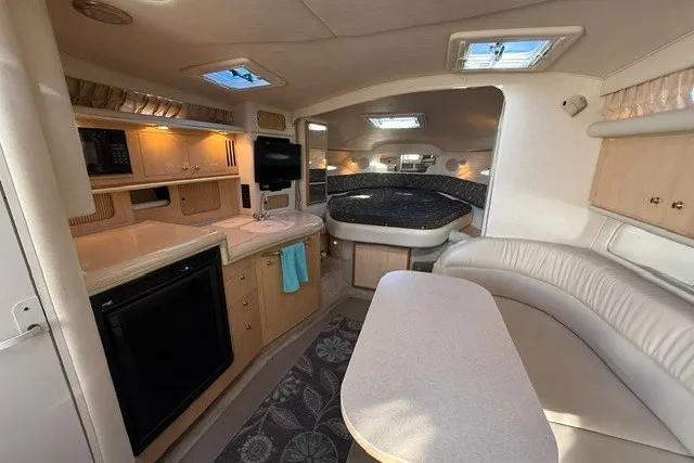 Slide: The Image of Interior of 2000 Sea Ray 340 Sundancer yacht with kitchen, seating, and sleeping area. - 28