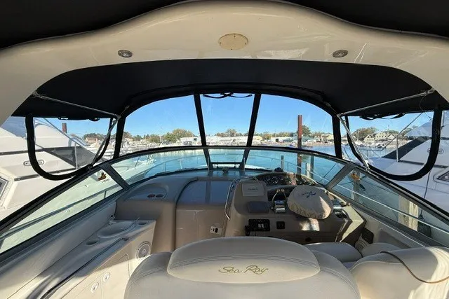 Slide: The Image of Cockpit view of a 2000 Sea Ray 340 Sundancer yacht at a marina. - 12