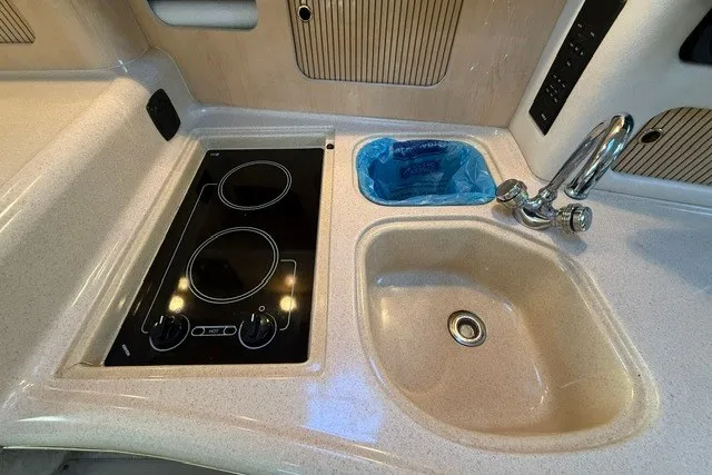 Slide: The Image of 2000 Sea Ray 340 Sundancer kitchen with stove, sink, and faucet. - 33