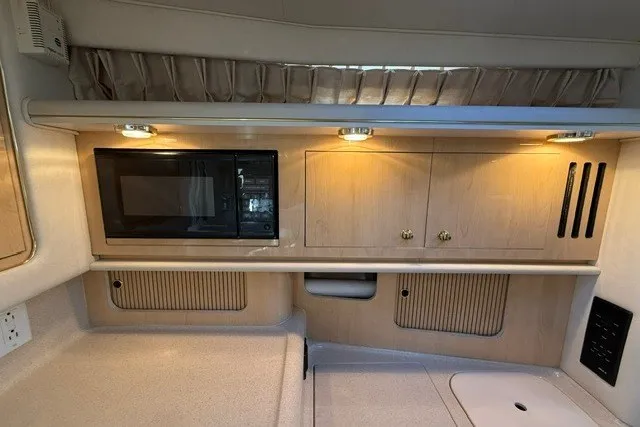Slide: The Image of Interior of 2000 Sea Ray 340 Sundancer with microwave and wooden cabinetry. - 34