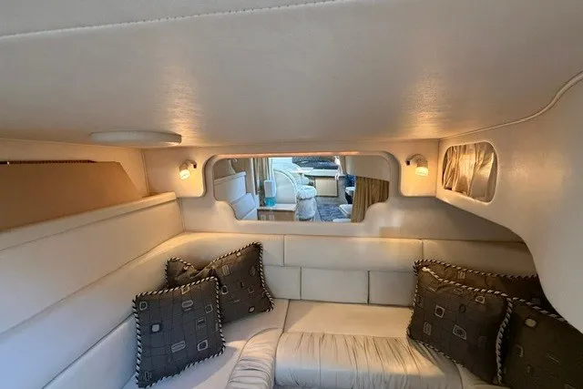Slide: The Image of Interior of 2000 Sea Ray 340 Sundancer with cozy seating and decorative pillows. - 51