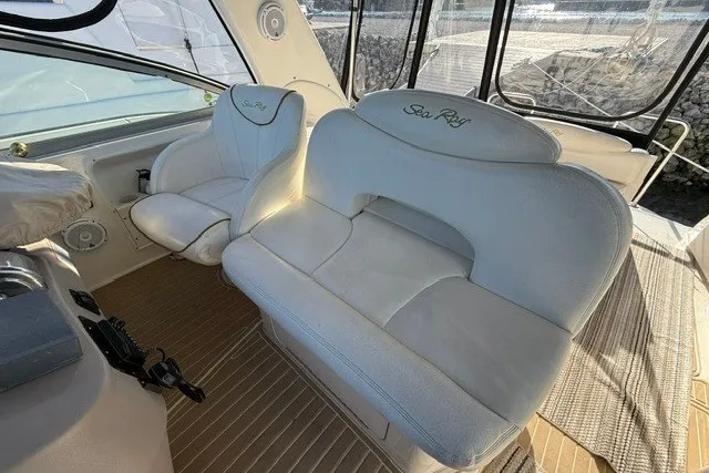 Slide: The Image of White leather seating on 2000 Sea Ray 340 Sundancer boat, featuring elegant design and comfort. - 18