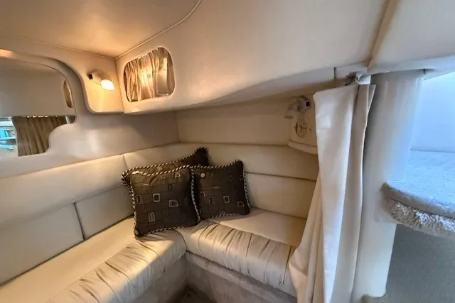 Slide: The Image of Interior of 2000 Sea Ray 340 Sundancer with cozy seating and decorative pillows. - 53
