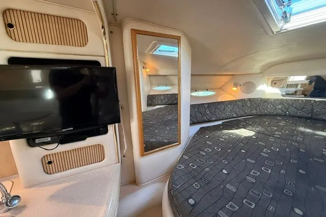Slide: The Image of Interior of 2000 Sea Ray 340 Sundancer with TV, mirror, and cozy seating area. - 39