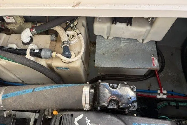 Slide: The Image of Engine compartment of a 2000 Sea Ray 340 Sundancer boat, showing mechanical components. - 56