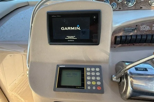 Slide: The Image of Dashboard of a 2000 Sea Ray 340 Sundancer with Garmin and Raytheon navigation systems. - 24