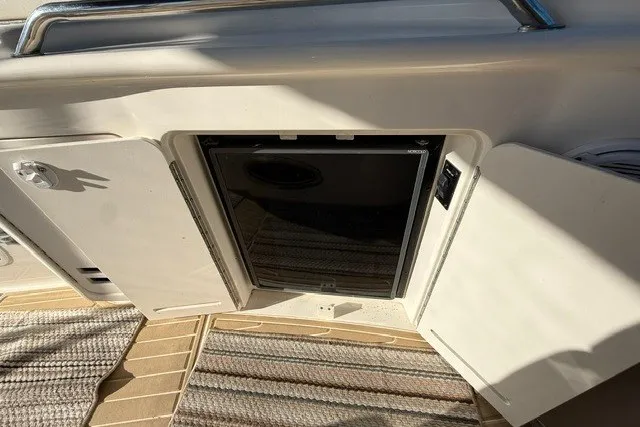Slide: The Image of Mini fridge on 2000 Sea Ray 340 Sundancer yacht, open cabinet, striped floor mats. - 15