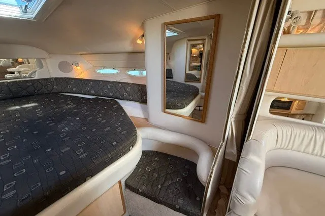 Slide: The Image of Interior of 2000 Sea Ray 340 Sundancer yacht with cozy sleeping area and mirror. - 38