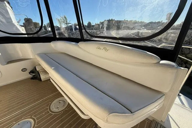 Slide: The Image of 2000 Sea Ray 340 Sundancer boat interior with white seating and clear windows. - 10