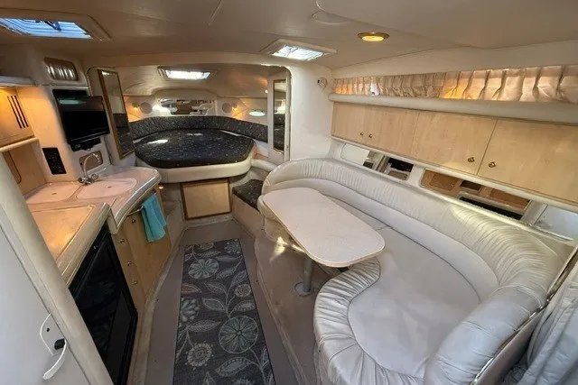 Slide: The Image of Interior of 2000 Sea Ray 340 Sundancer yacht with cozy seating and kitchenette. - 27